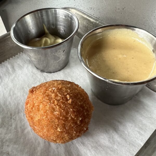 Arancini with two types of dips in steel glasses