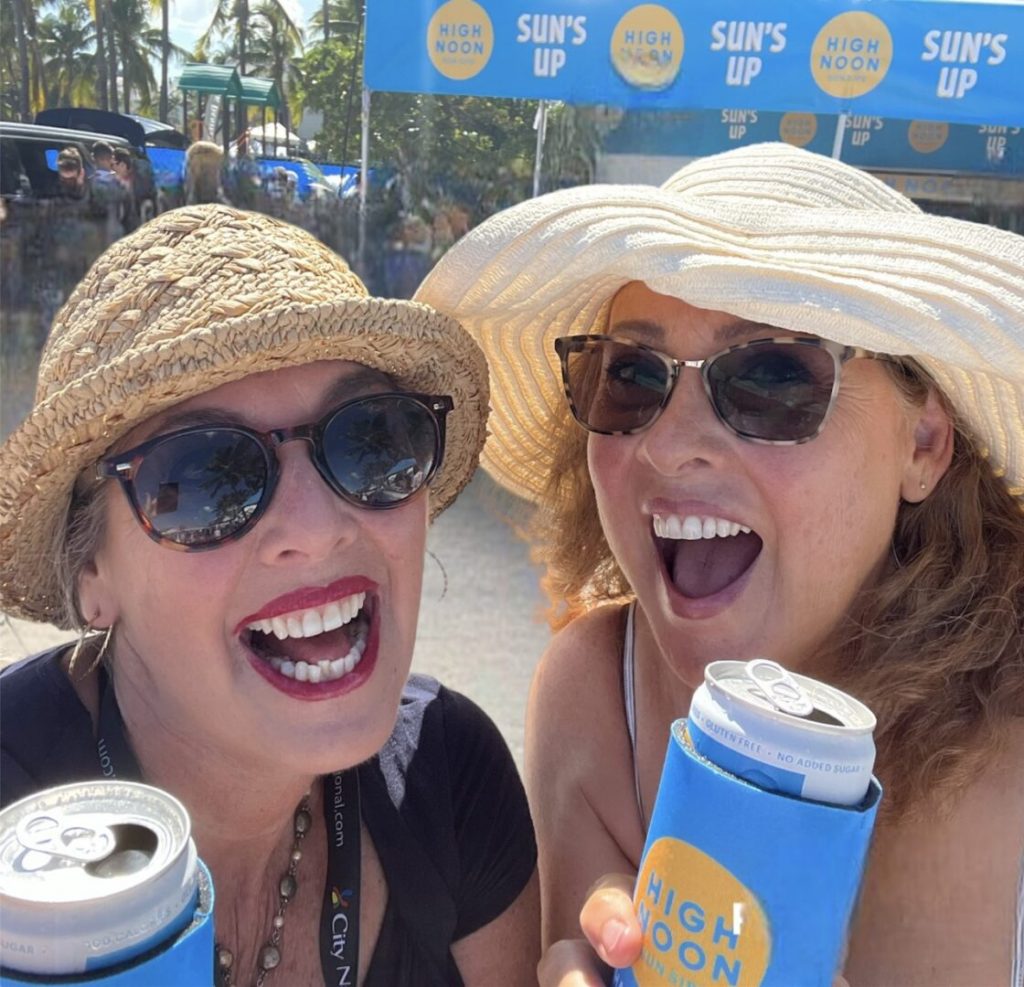 Two women wearing hats and glasses